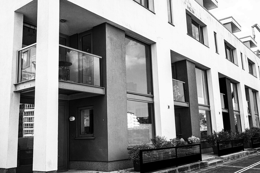 black and white image of block of modern flats