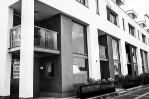 black and white image of block of modern flats